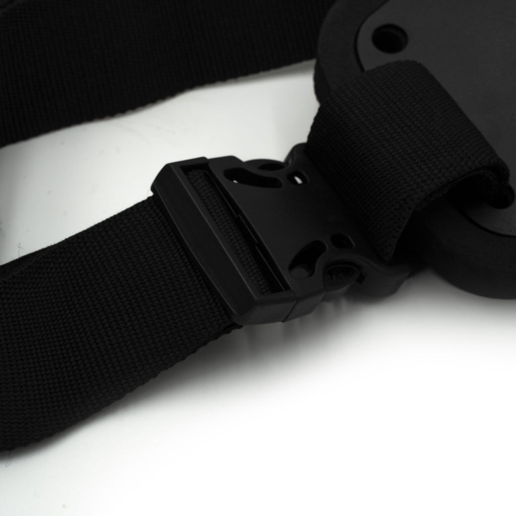 Close-up of a black belt with a buckle on a white background