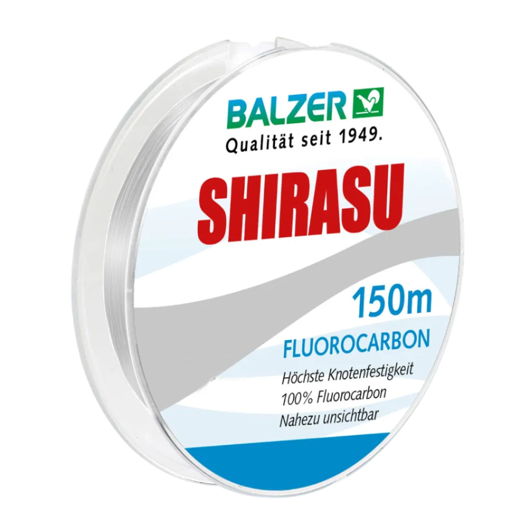 A spool of Balzer Shirasu fluorocarbon fishing line, 150 meters, shown on a clean white background. The spool features a clear plastic outer casing and a white label with blue and red text.