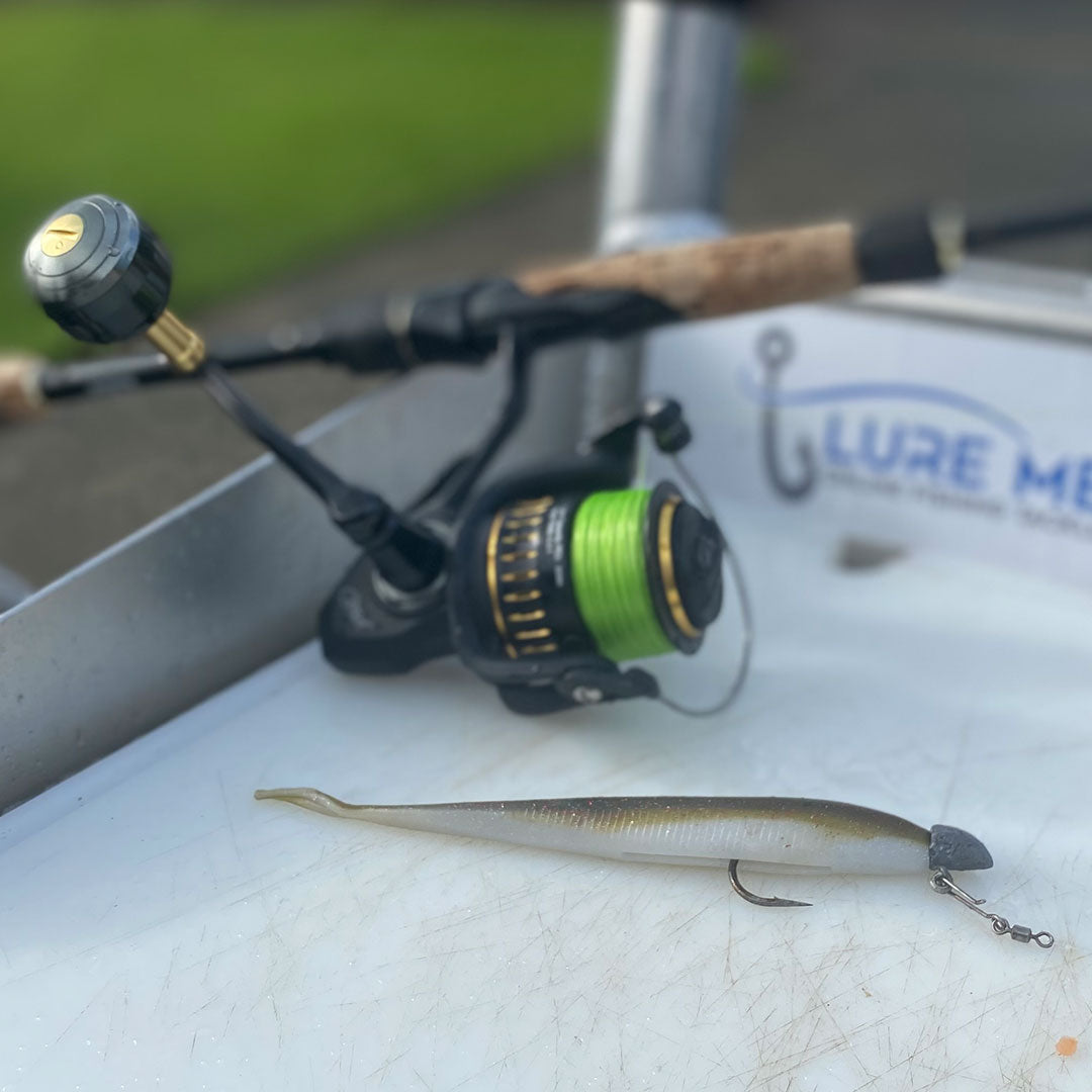 Fishing rod with reel and lure on a boat deck