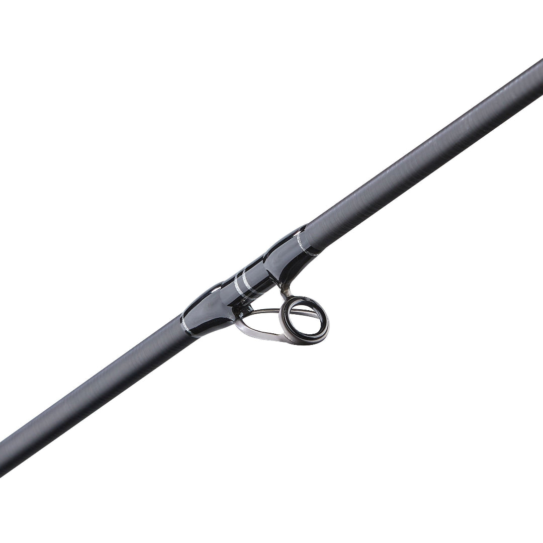 A close-up of a black fishing rod section with a metallic ring and guide, shown diagonally on a plain white background.