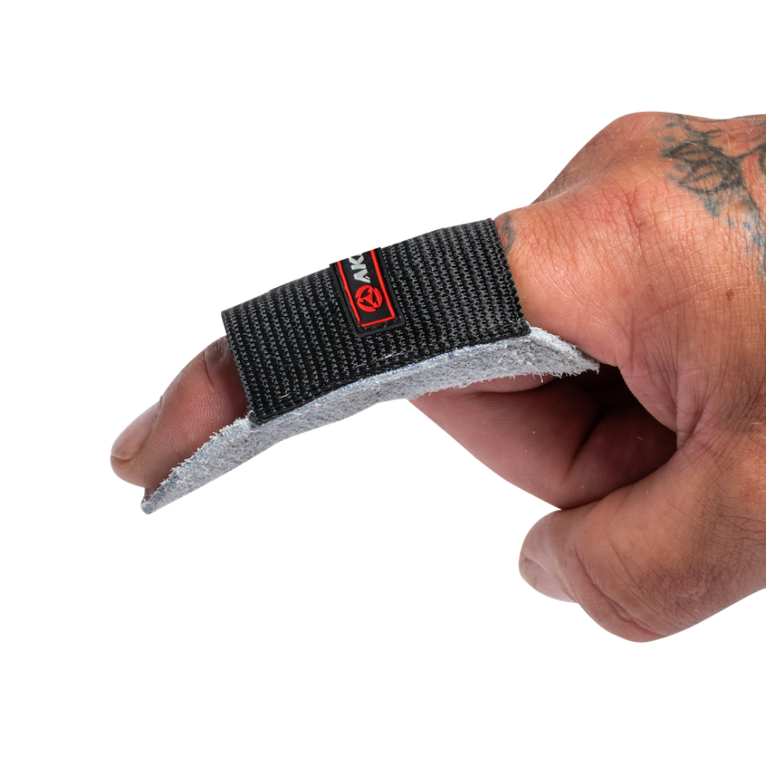 Hand wearing a black and gray wrist support with a brand logo on a white background