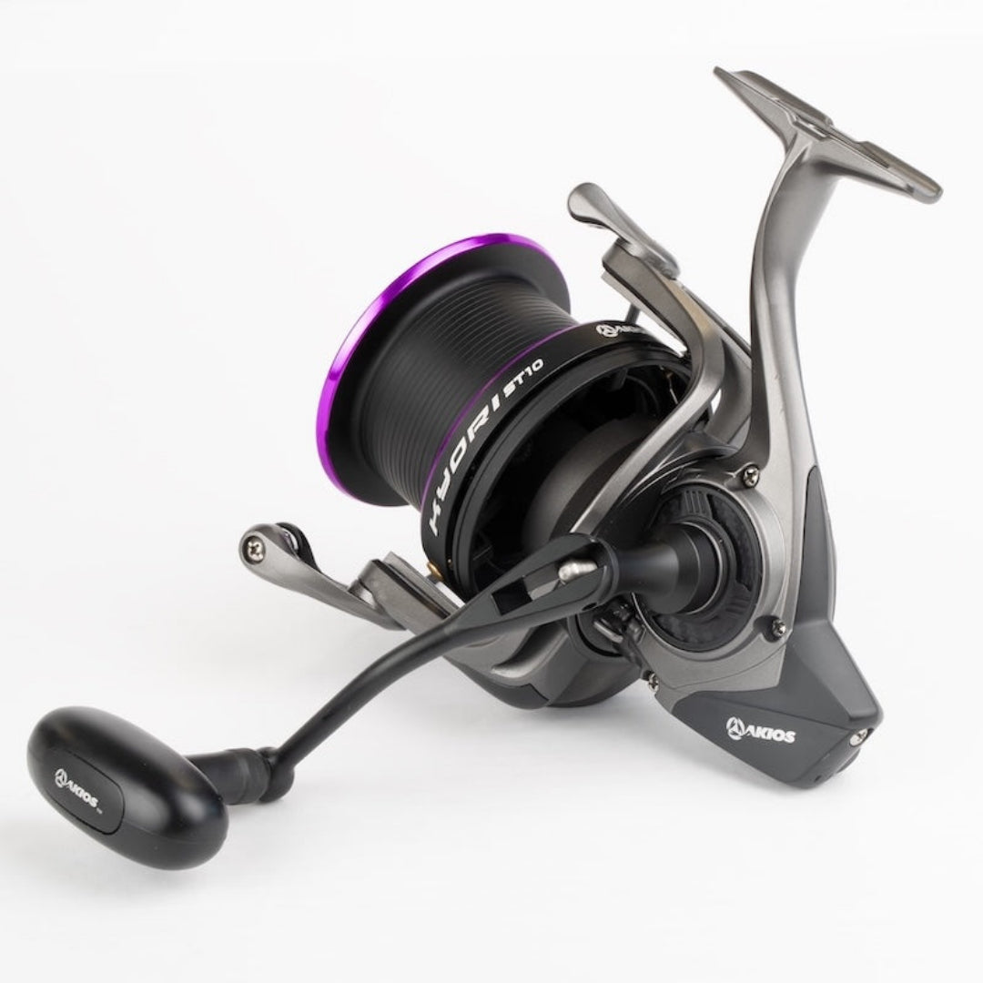 Fishing reel with purple accents on a white background