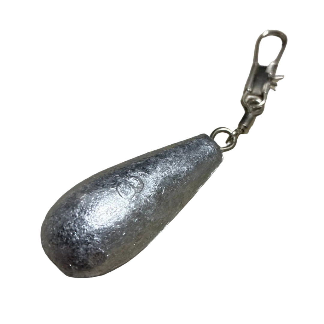 A silver metallic teardrop-shaped fishing sinker with a silver split ring and lobster clasp, resting on a textured gray stone surface.