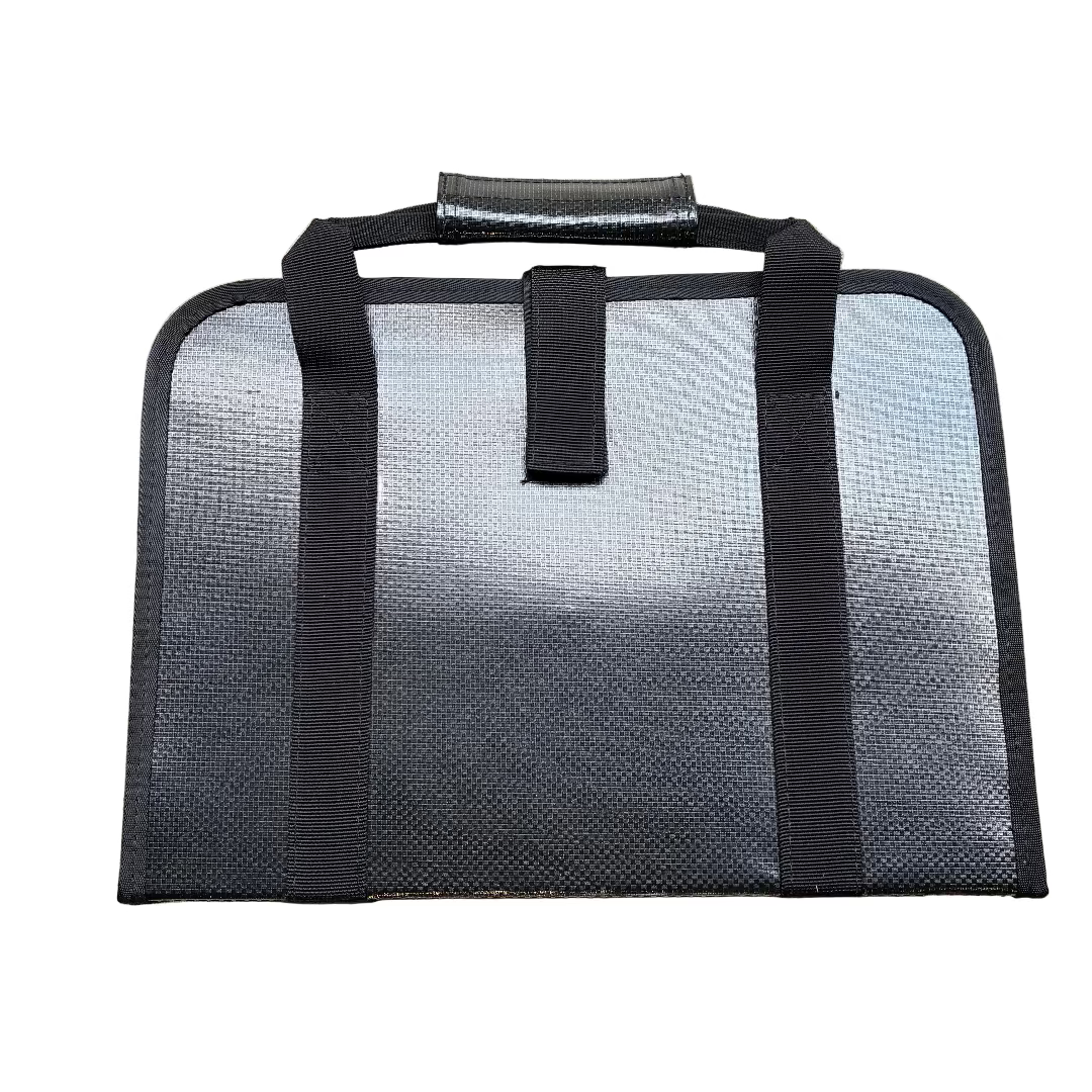 Black mesh bag with straps on a textured surface