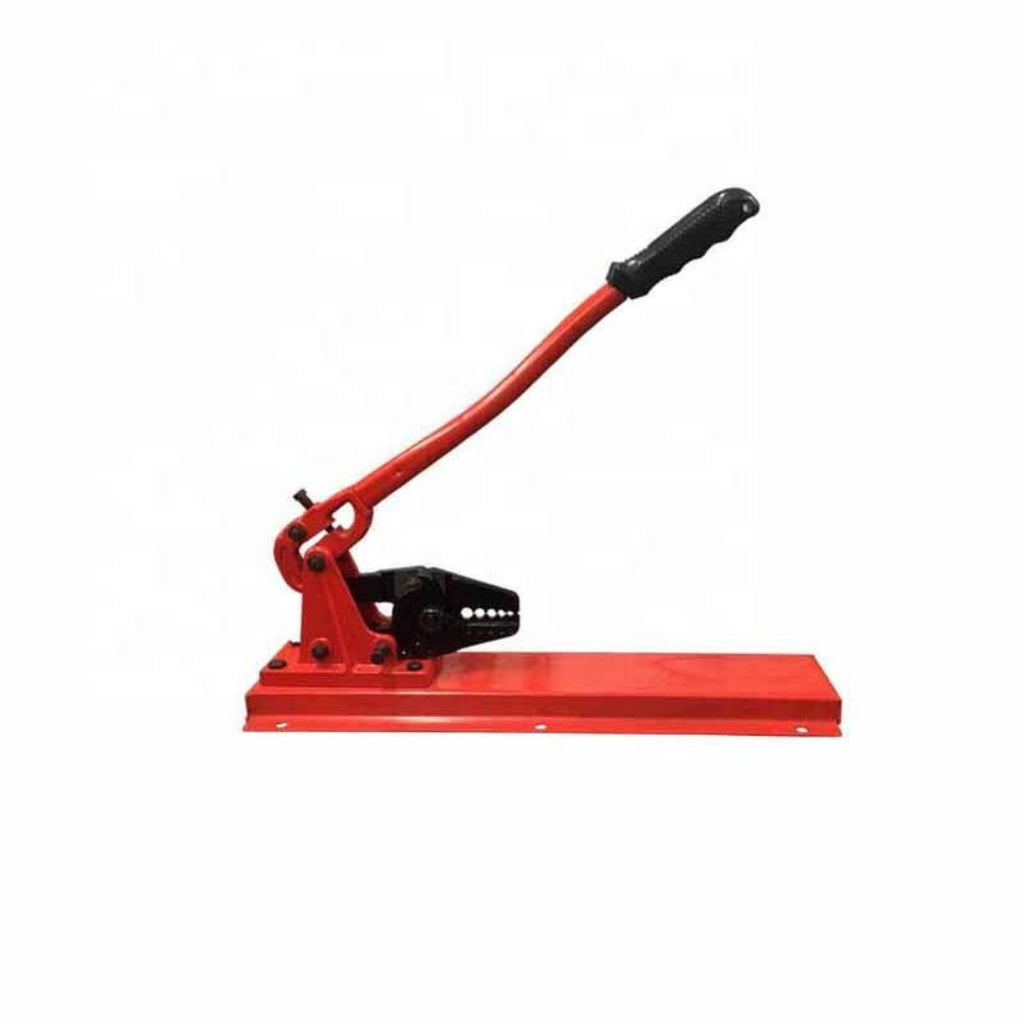 Red manual press tool with a black handle on a white background