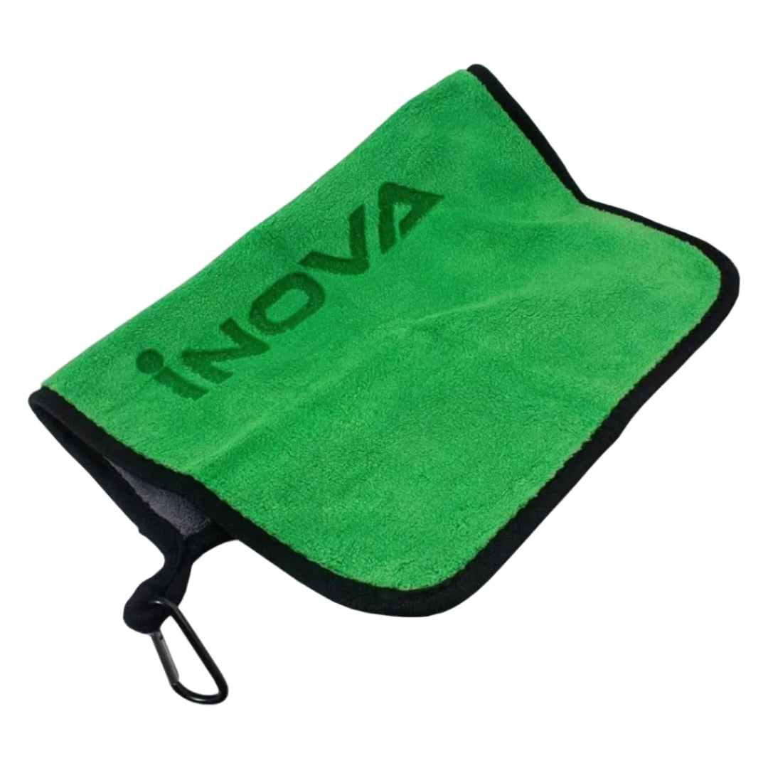 A green microfiber cleaning cloth with black trim and a black carabiner clip, featuring the brand name 'iNOVA' printed in dark green on the front, set against a plain white background.