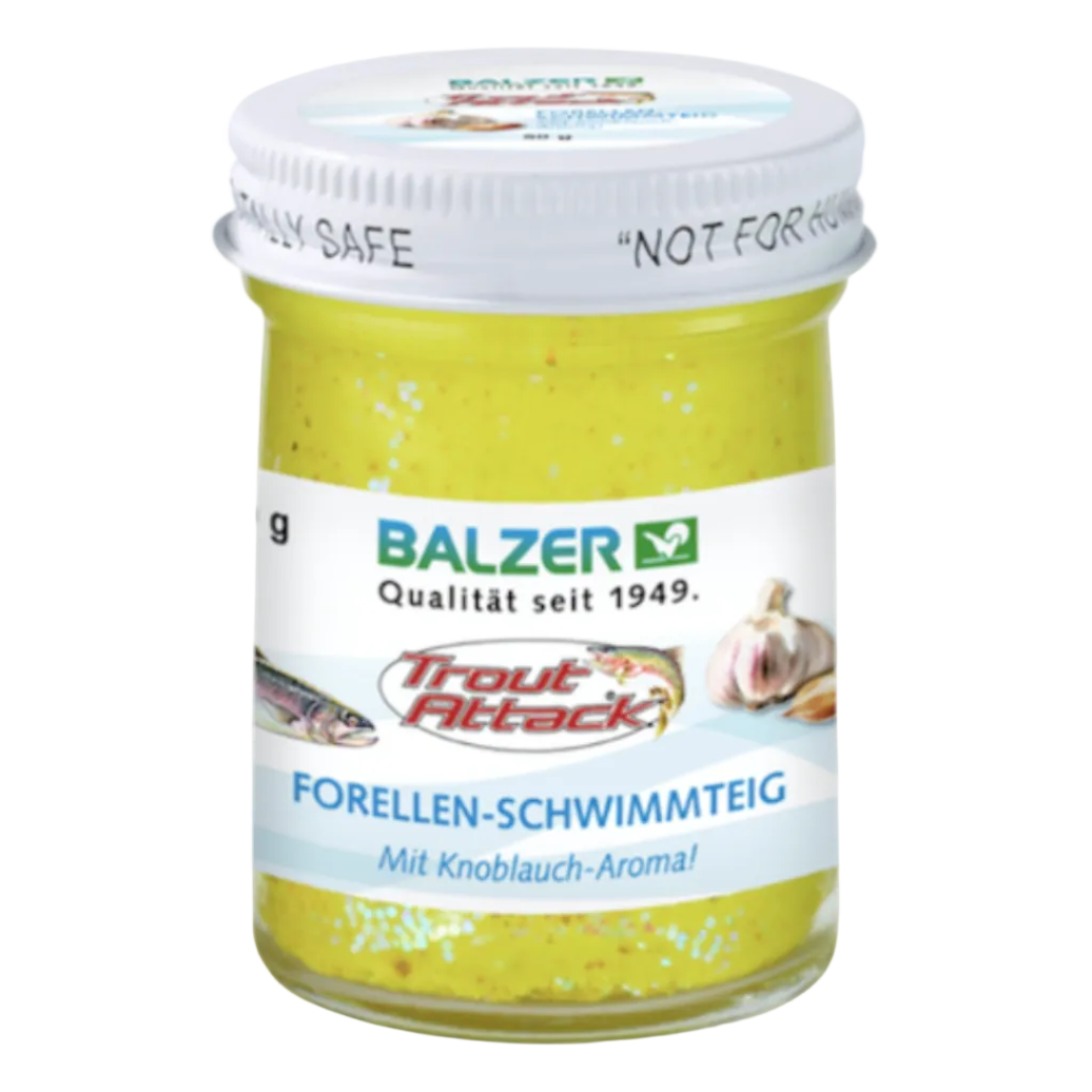 A jar of Balzer Trout Attack fishing bait, specifically Forellen-Schwimmteig, featuring a white lid and a white label with blue and red text, containing a yellow-green bait mixture.