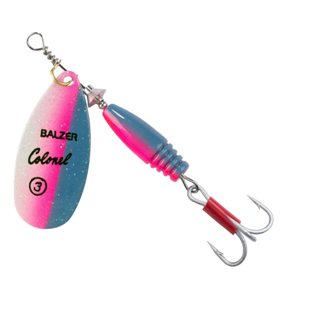 A Balzer Colonel fishing lure with a split pink and blue glitter blade, a blue and pink ribbed body, and a red section near the hooks, shown on a white background.