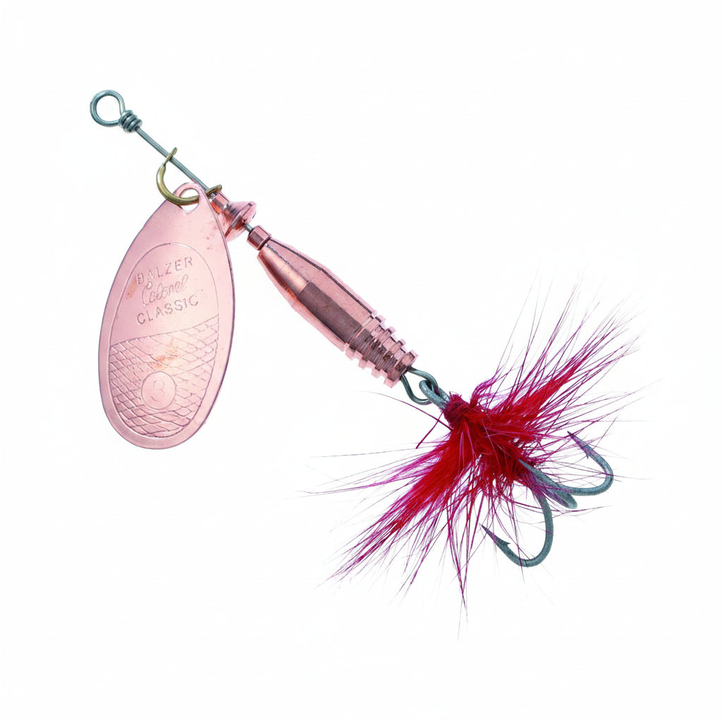 Pink fishing lure with red and white feather on a white background