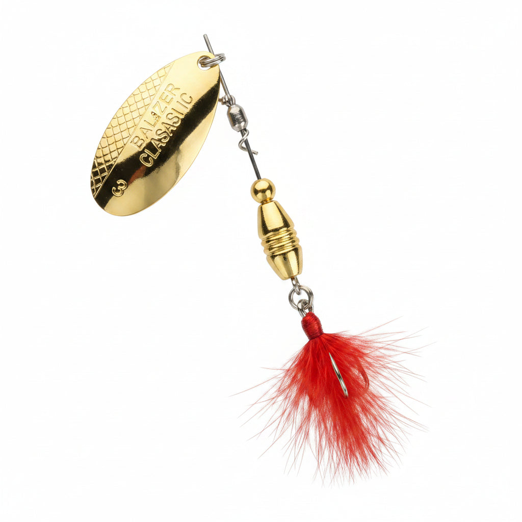 Gold and red fishing lure on a white background