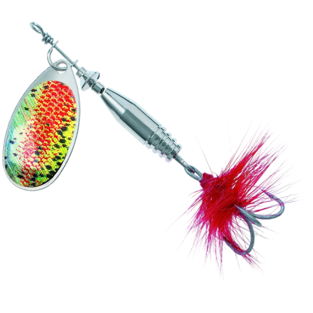 A close-up studio shot of a fishing spinnerbait lure on a solid white background. The lure features a silver metal blade with a vibrant, multicolored scale pattern in red, yellow, and green, attached to a silver spinner body and a bright magenta-pink synthetic hair skirt with a hook.