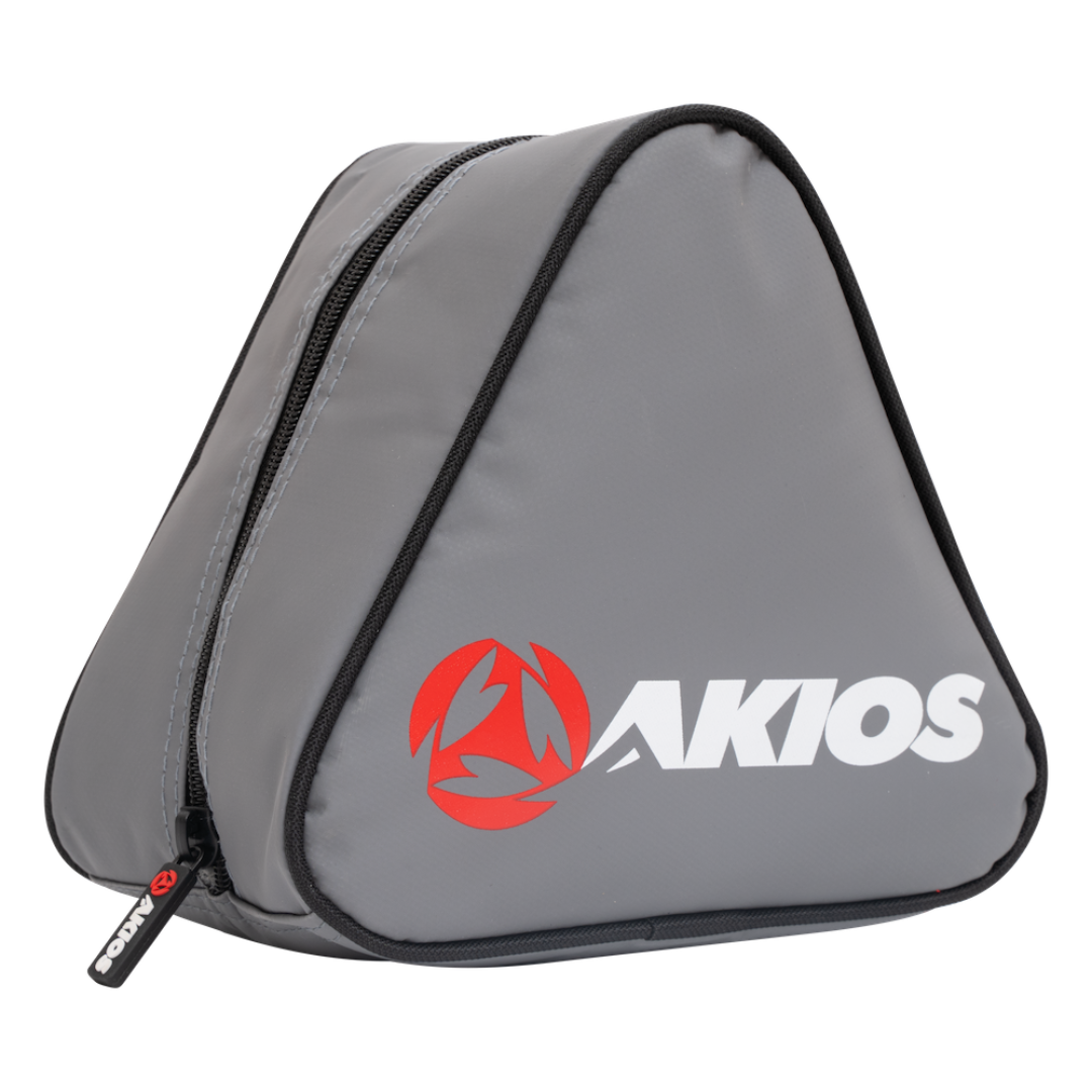 A gray triangular zippered fising reel case with black trim and a large red and white AKIOS logo on the front, shown on a plain white background.