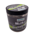 A jar of Balzer MK Adventure Matze's Boost Tip Off fishing product, featuring a black lid and a dark gray label with green and white accents, set against a plain light gray background.