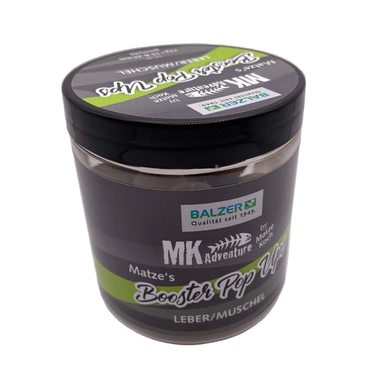 A jar of Balzer MK Adventure Matze's Boost Tip Off fishing product, featuring a black lid and a dark gray label with green and white accents, set against a plain light gray background.