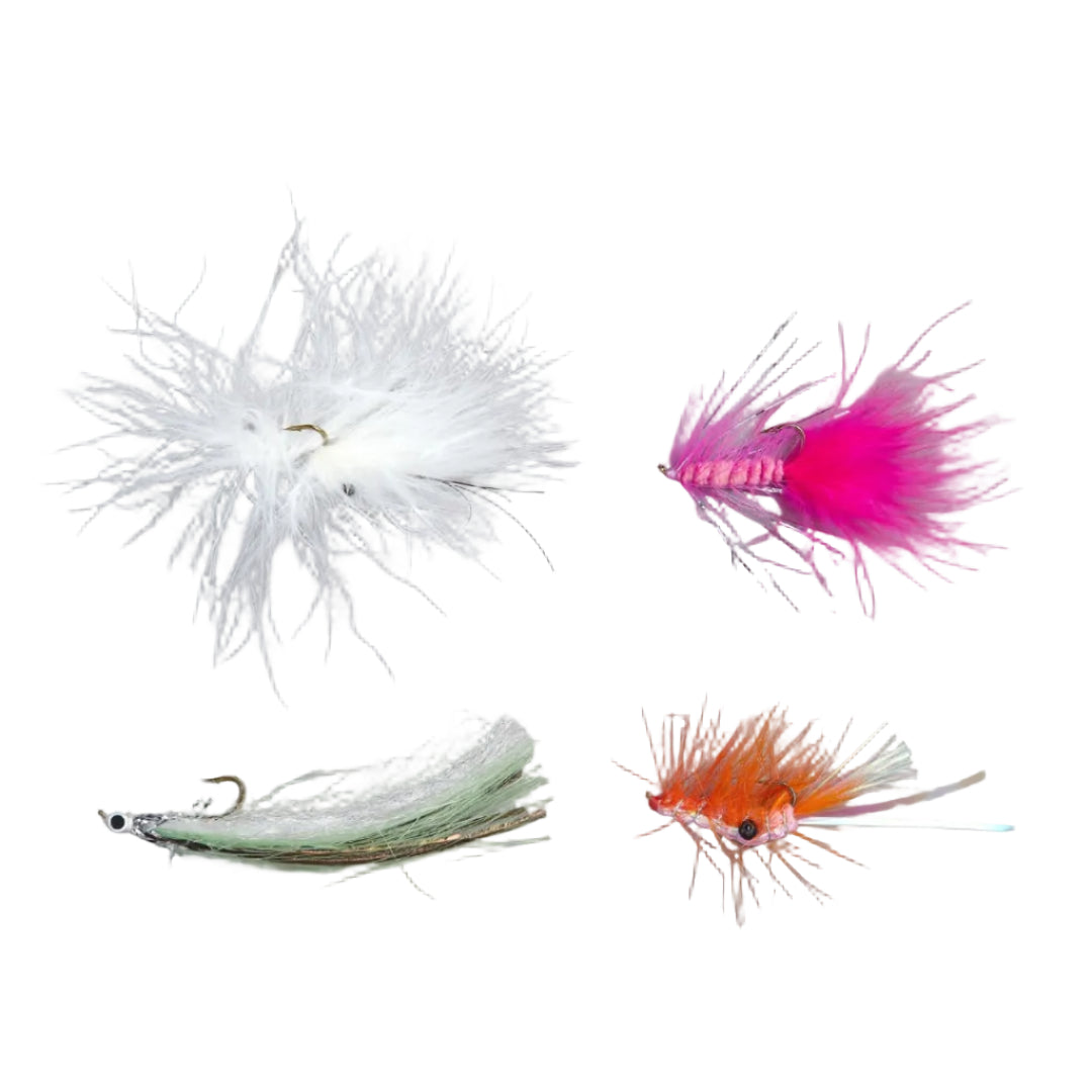 Four artificial fly fishing lures arranged on a plain gray background: a fluffy white feather fly, a bright pink fuzzy fly, a pale green and white fly with a silver eye, and an orange and white fly with a silver tail.