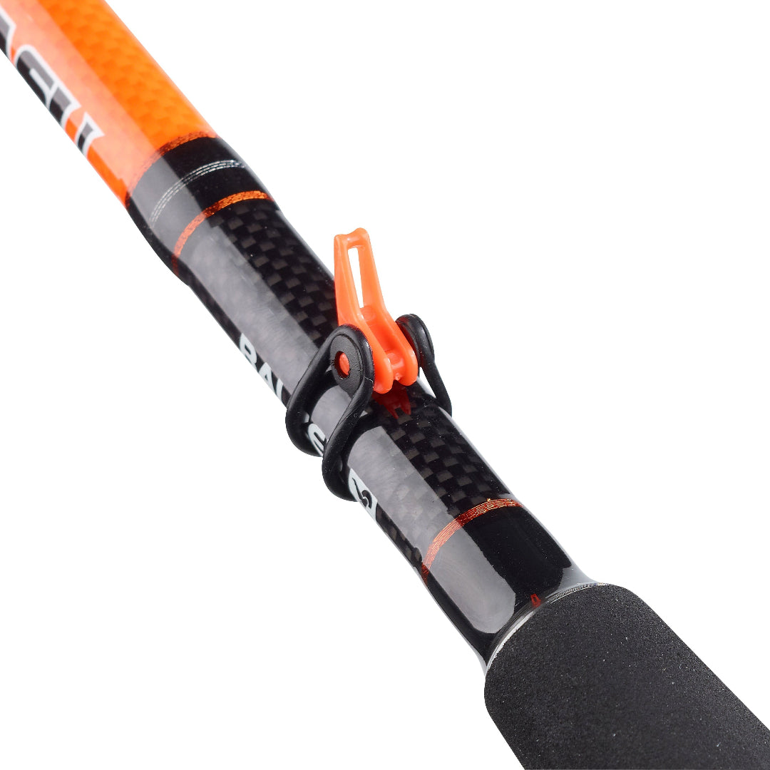 Close-up of a carbon-fiber fishing rod section with a bright orange handle grip and an orange-and-black accessory clamp near the center, shown on a white background.