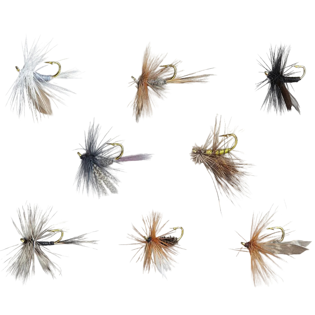 Collection of various fly fishing flies on a gray background